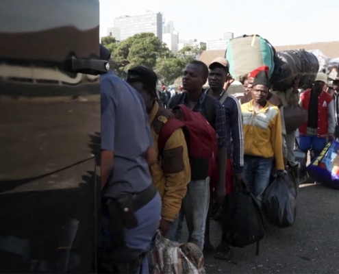 Migrants line up to leave South Africa on Monday, June 30, 2026, as an unofficial deadline set by anti-immigration groups demanding their departure took effect. Nearly 25,000 foreign nationals left the country amid the crisis, while many others sought refuge in community centers, churches and makeshift camps. Screenshot / Sky News