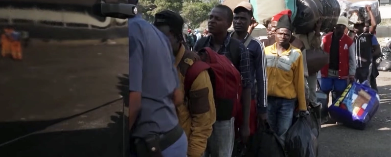 Migrants line up to leave South Africa on Monday, June 30, 2026, as an unofficial deadline set by anti-immigration groups demanding their departure took effect. Nearly 25,000 foreign nationals left the country amid the crisis, while many others sought refuge in community centers, churches and makeshift camps. Screenshot / Sky News